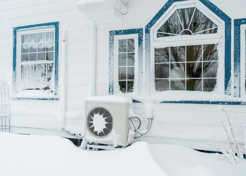 heat pump covered in snow