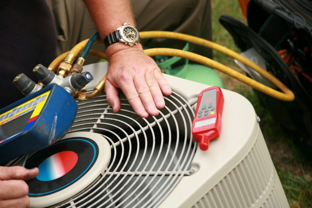 man diagnosing central ac unit issues