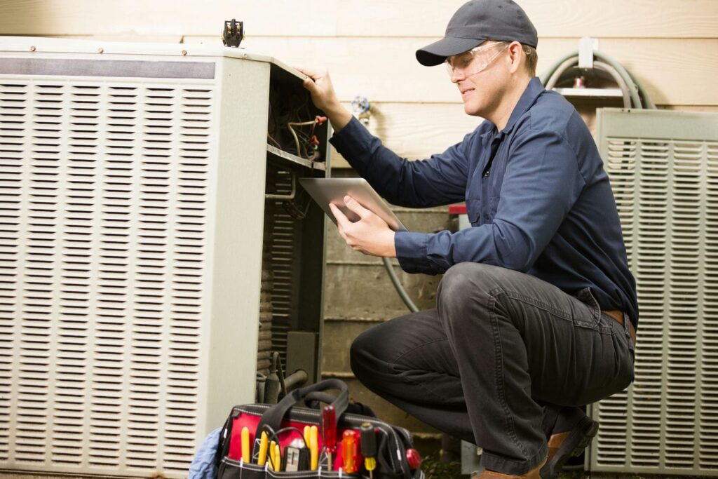 An installer carefully setting up an AC unit, showing installation quality can beat a bigger SEER2 number