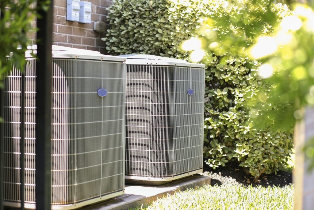 Outdoor air conditioner condenser running hard in summer heat where breaker trips often originate